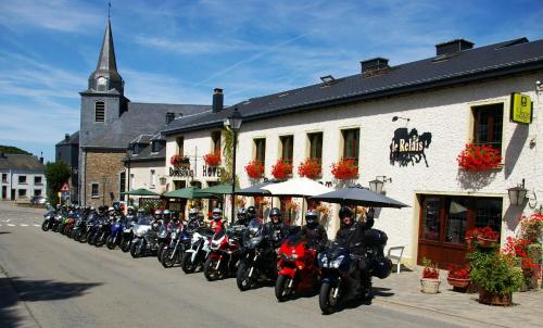 a line of motorcycles parked in front of a building at Auberge Le Relais in Corbion
