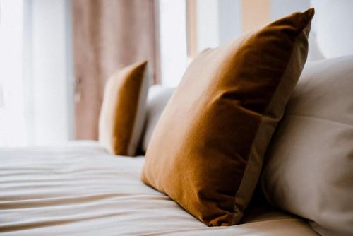 two pillows sitting on top of a bed at Panoramic Villa Garassino - country rooms and fine restaurant in Treiso