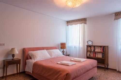 a bedroom with a bed with two towels on it at Ca' Magno by Venicevillas in Venice