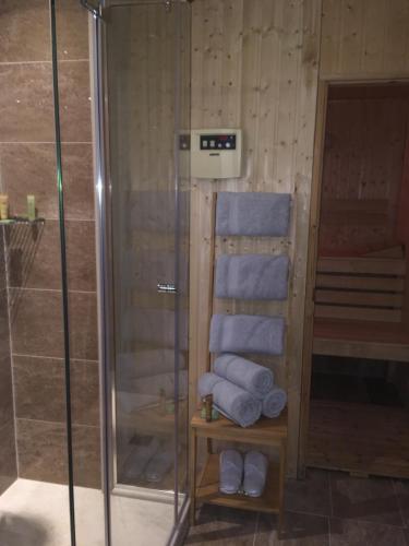 a stack of towels in a bathroom with a shower at Villa Promenade in Burgas City