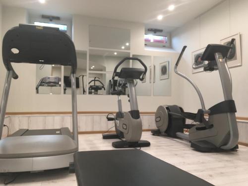 a gym with several exercise bikes and a mirror at Villa Promenade in Burgas City