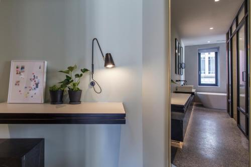 a hallway with desks and potted plants on a wall at Perianth Hotel, a Member of Design Hotels in Athens