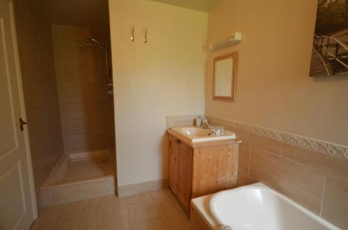 a bathroom with a tub and a sink and a shower at Woodland Guesthouse in Stow on the Wold