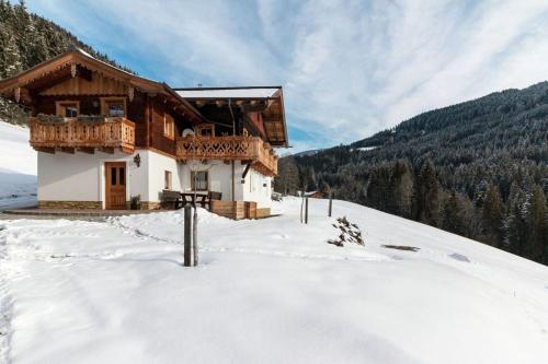 a house on a snow covered hill in the snow at Bauernhütte Niedermaisgut in Eben im Pongau