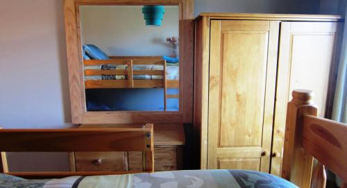 a bedroom with a bunk bed and a mirror at 8B Calbost in Calbost