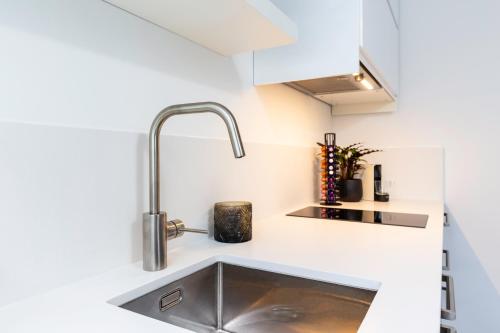 a kitchen with a sink and aaucet at Original twin Studio Delft City Central Station 30B in Delft