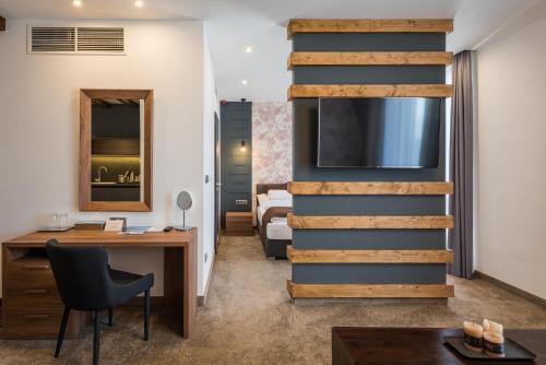 an office with a desk and a staircase in a room at Várda Sport Hotel in Kisvárda
