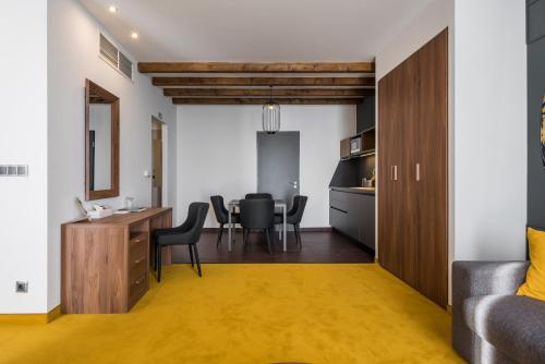a kitchen and living room with a table and chairs at Várda Sport Hotel in Kisvárda