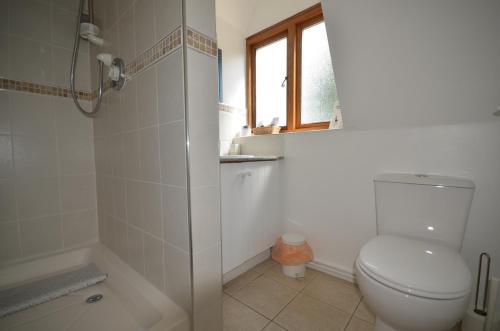 a bathroom with a toilet and a shower at Woodland Guesthouse in Stow on the Wold