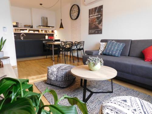 a living room with a couch and a table at New cosy apartment near Arena in Zagreb