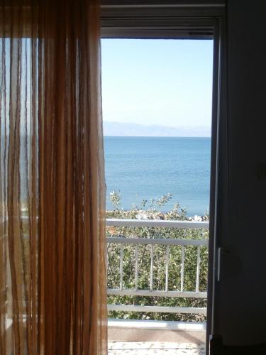 a window with a view of the ocean at Hotel Prinos in Prinos