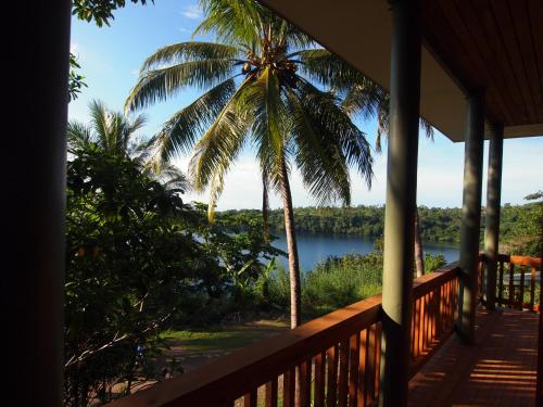 a view from the porch of a resort with a palm tree at Tufi Resort in Tufi