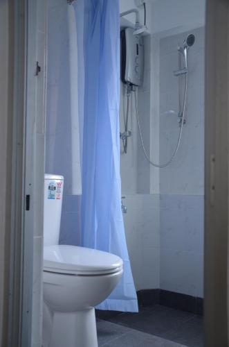 a bathroom with a toilet and a shower at Ripple Reach Apartments in Galle
