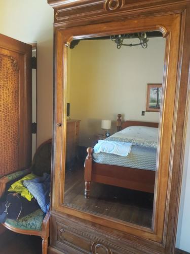 a large mirror in a bedroom with a bed at Casa Carmel Bed & Breakfast in Guatemala