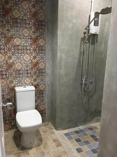 a bathroom with a toilet and a shower at Thaimueang Boutique Hotel in Thai Muang