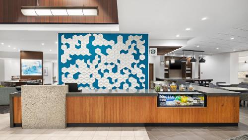 a restaurant counter with a blue and white wall at Hyatt Place Jacksonville St. Johns Town Center in Jacksonville