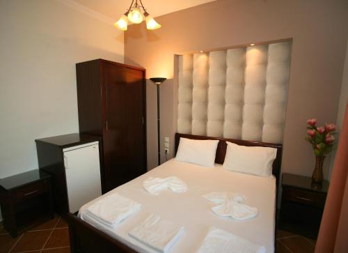 a bedroom with a bed with two towels on it at Elena Rista Studios in Parga