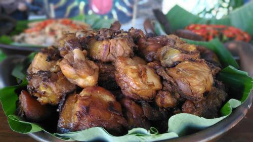 a bowl of food with chicken and other foods at Balkondes Wanurejo in Borobudur