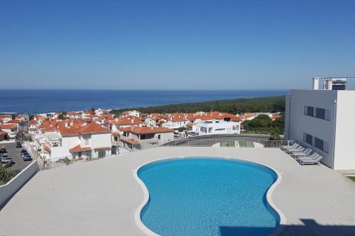 arial view of a swimming pool on the roof of a building at Marnix´s Apartment in Nazaré