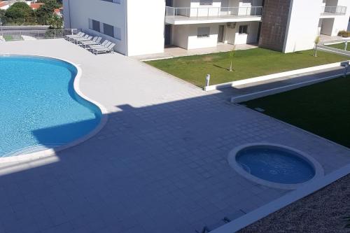a swimming pool on the side of a building at Marnix´s Apartment in Nazaré