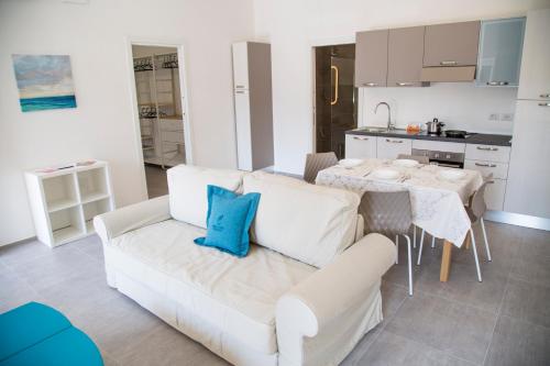 sala de estar con sofá blanco y mesa en Rivabella Suite Apartments, en Rímini