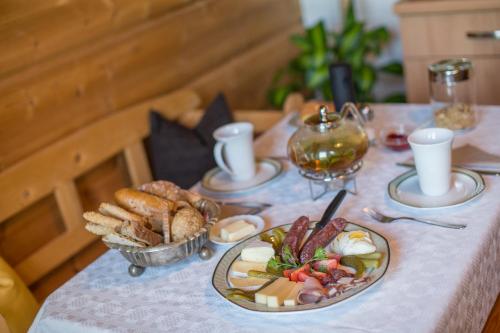 a table with plates of food and bread on it at Schlossblick in Vols am Schlern
