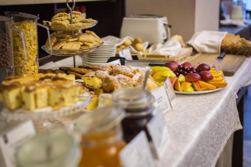 a buffet of food on a table with fruit at Optima Dworzec Lviv in Lviv