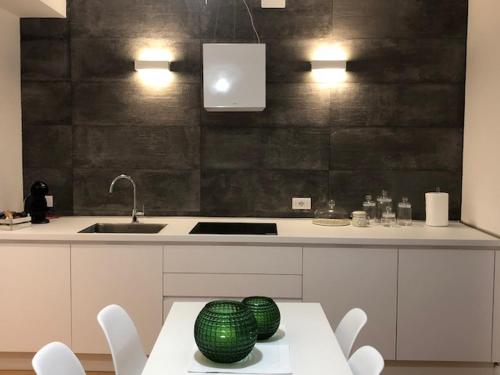 a kitchen with a table with two green spheres on it at Home Sweet Home in Treviso