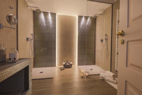 a bathroom with a shower and a glass shower stall at Relais Masseria Caselli in Carovigno