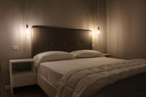 a bedroom with a large bed with two pillows at Boutique Hotel Palazzo Corso Umberto in Boiano