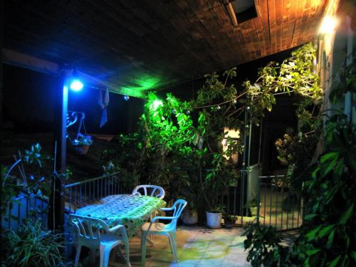 a patio with a table and chairs at night at Diana's B&B in Jerusalem