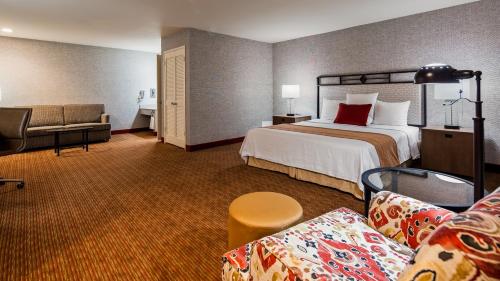 a hotel room with a bed and a couch at SureStay Hotel by Best Western Camarillo in Camarillo