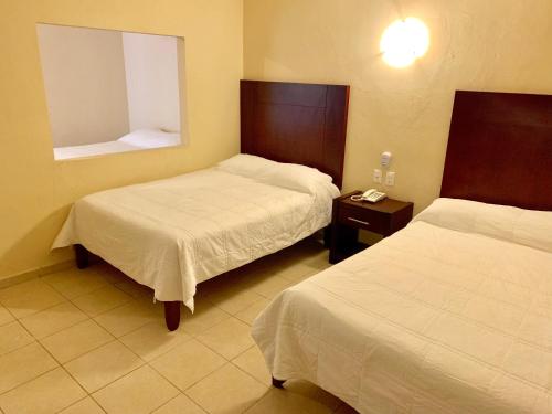 Postel nebo postele na pokoji v ubytování Hotel Cosmos