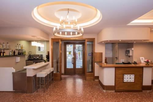 a large kitchen with a large chandelier at Evenia Oros in Encamp