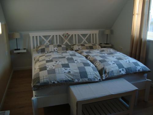 a bedroom with a bed with a quilt on it at Haus Nordlicht in Horn-Bad Meinberg