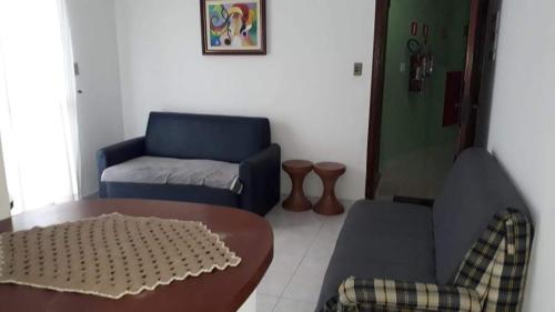 a living room with a couch and a table at Vila Caiçara Nice Location - Linda Vista ! in Solemar