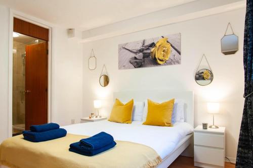 a bedroom with two blue pillows on a bed at The Queensborough Apartments by Hyde Park in London