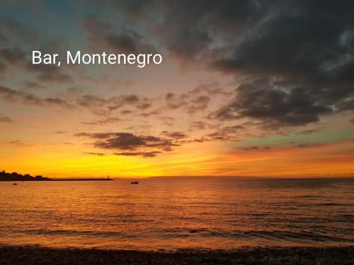 a sunset over the ocean with the words bar montenegro at Guesthouse Berlin in Bar