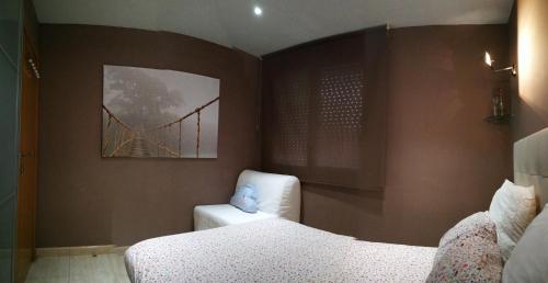 a bedroom with a bed and a yellow bridge at White Stones Beach In Sant Pol de Mar in San Pol de Mar