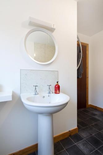 a bathroom with a white sink and a mirror at Skye View in Glenelg