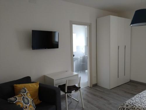 a living room with a couch and a tv on a wall at Novantatrè in Campobasso