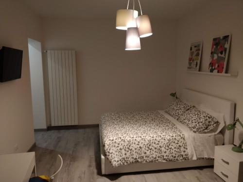 a bedroom with a bed and a chandelier at Novantatrè in Campobasso