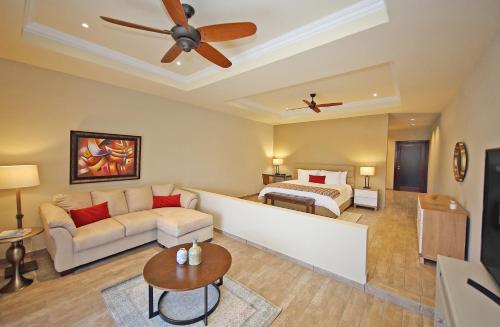 a living room with a couch and a bed at Los Establos Boutique Resort - All Inclusive in Boquete
