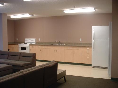 Habitación con cocina con nevera y sofá. en University of Alberta - Accommodation en Edmonton