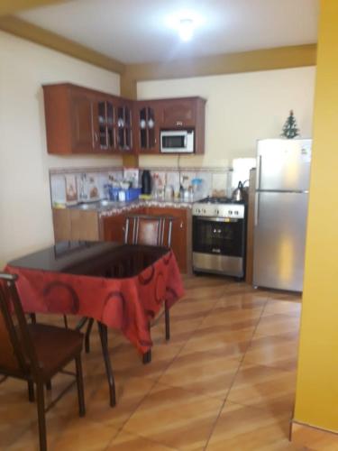 a kitchen with a table in the middle of it at El Marquez in Tacna