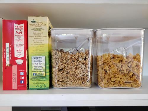 two containers of food sitting on a shelf at Knights in Residence in Tutukaka