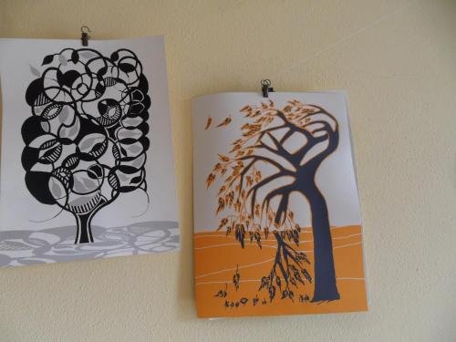 two posters hanging on a wall with a tree at B&B Casa Pascolone in Pegognaga