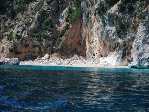 a beach in the middle of a rocky mountain at Country House S'Ozzastru in Dorgali
