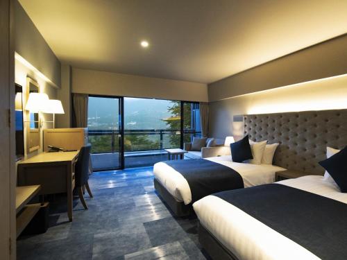 Ένα ή περισσότερα κρεβάτια σε δωμάτιο στο Hakone Elecasa Hotel and Spa