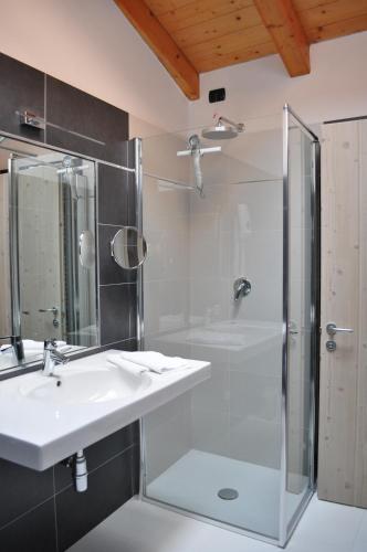 a bathroom with a sink and a shower at Ai Vellutai in Ala